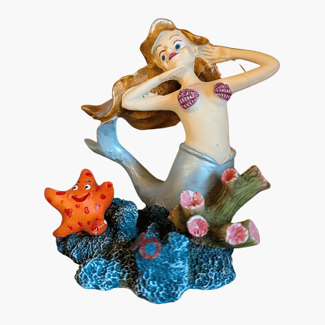 betta posing mermaid aquarium ornament against white background